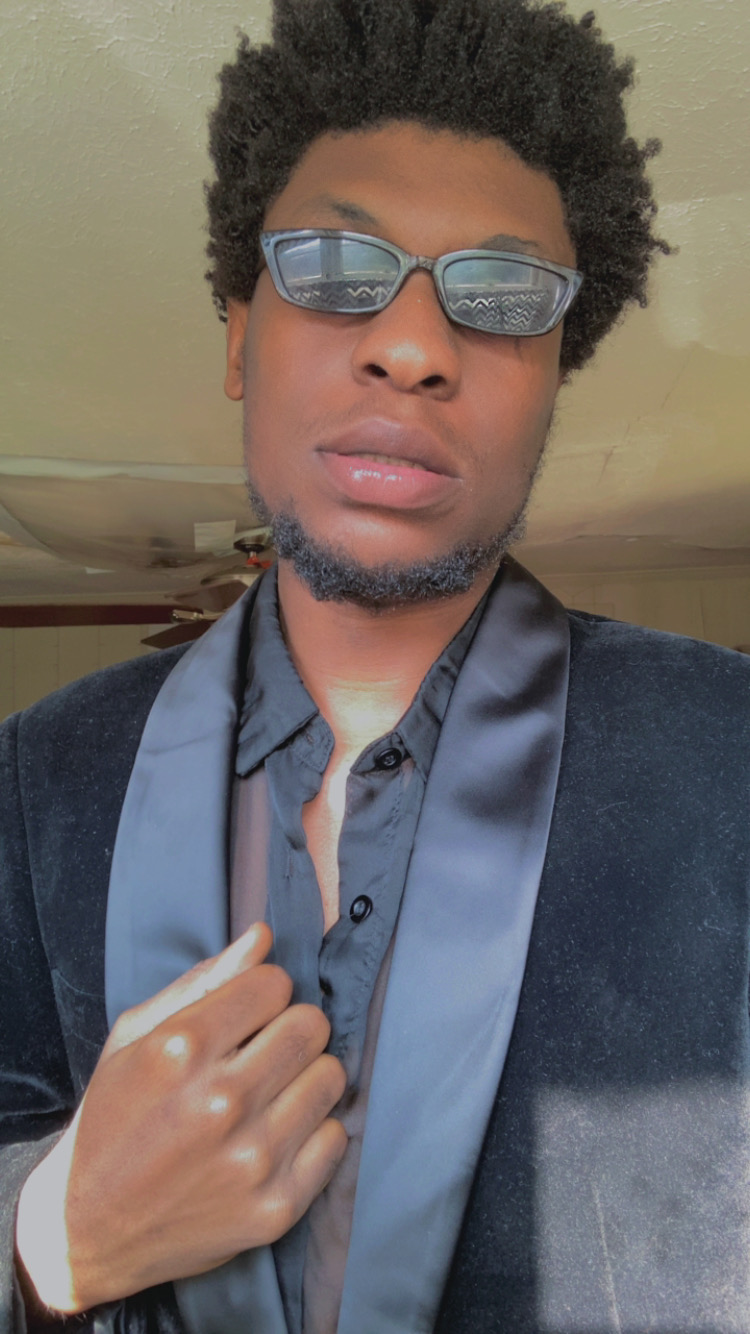JayHBK in a black velvet blazer and sunglasses